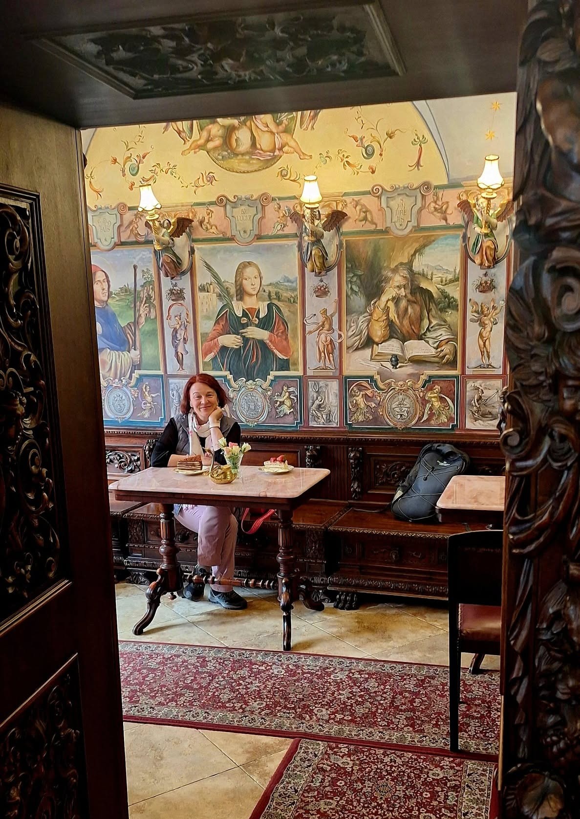 Edina enjoying coffee inside the art-filled Konditorei Kormuth in Bratislava